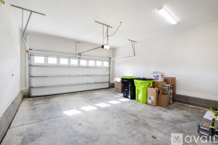 A large empty garage with a white wall and a white door.