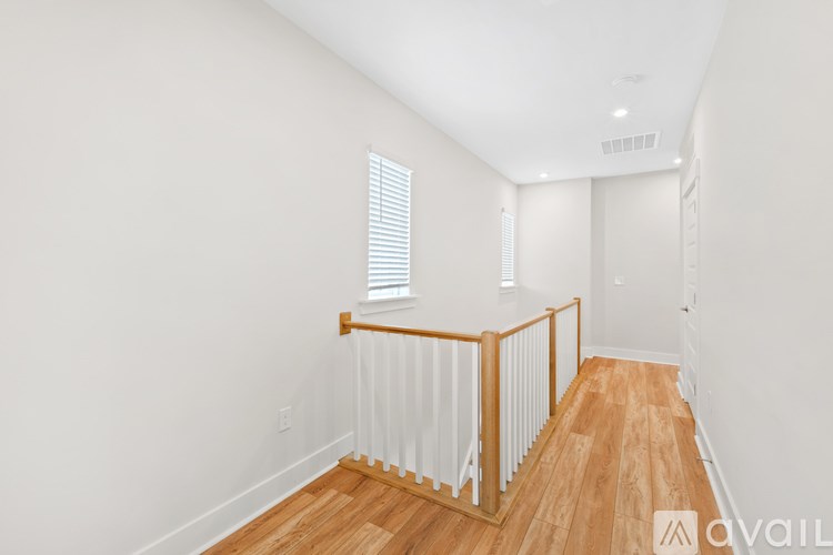 A room with wooden floors and white walls.