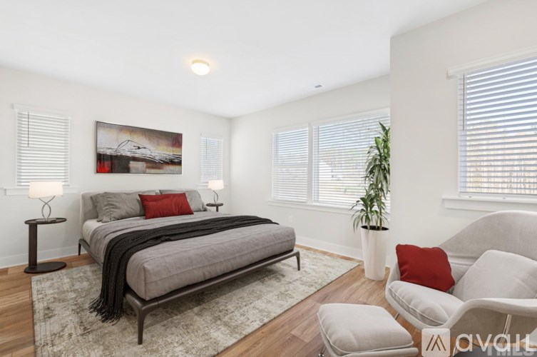 A bedroom with a large bed and a painting on the wall.