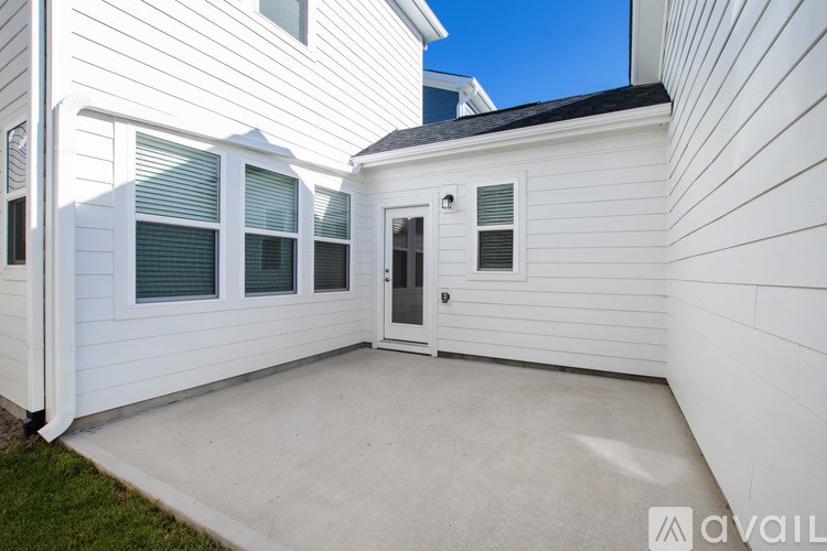 A white house with a black roof and a white door.
