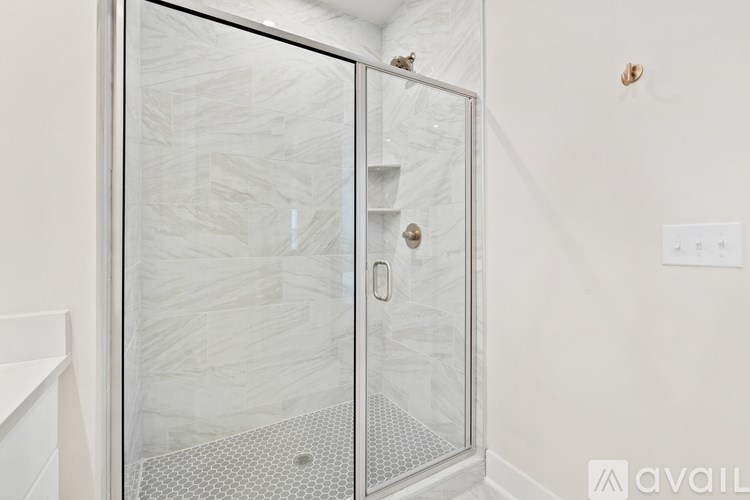 A glass shower door in a bathroom.