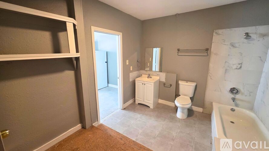 A bathroom with a toilet, sink, and bathtub.