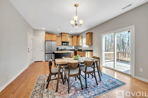 A dining room with a table set for four.