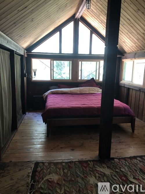 A bedroom with a bed in the middle of the room.