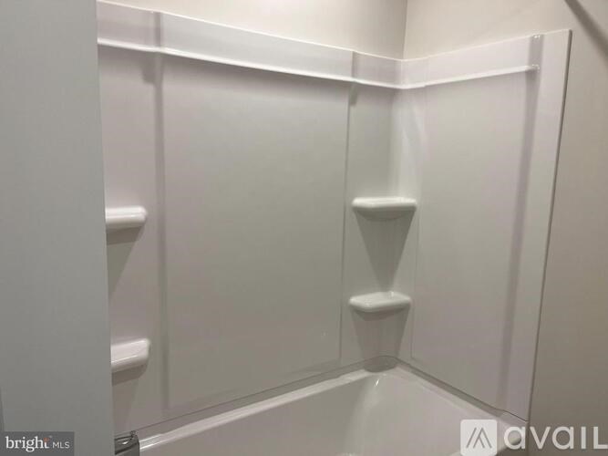A white pantry with shelves and a step stool.