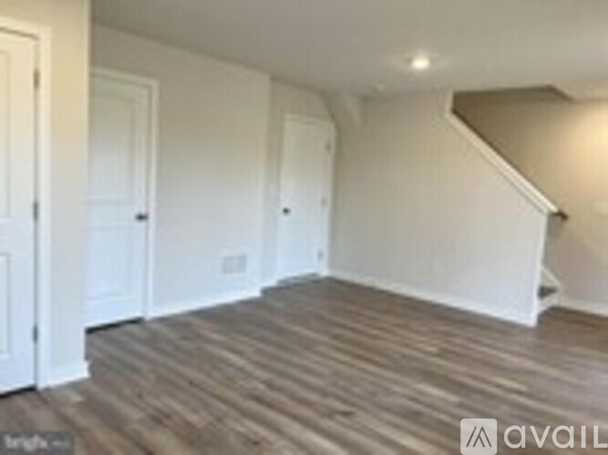 A room with wooden floors and white walls.