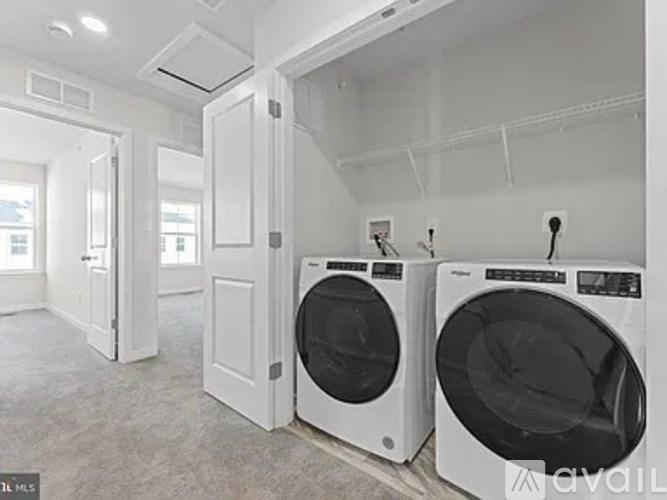 A laundry room with two front loading washing machines.