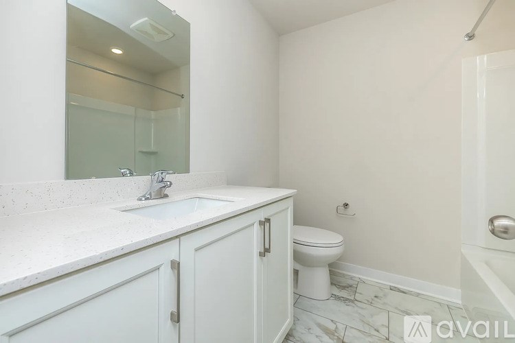 A bathroom with a sink, toilet, and bathtub.