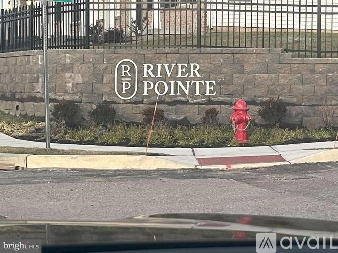A sign that says River Pointe is on a wall.
