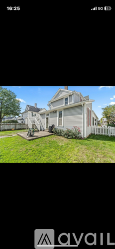 A house with a white picket fence is shown in the image.