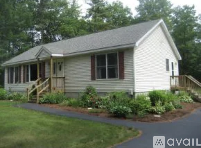 A house with a grey roof and a porch.