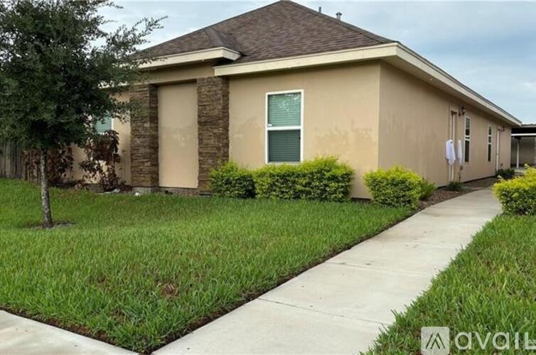 A house with a brown roof and beige walls is for sale.