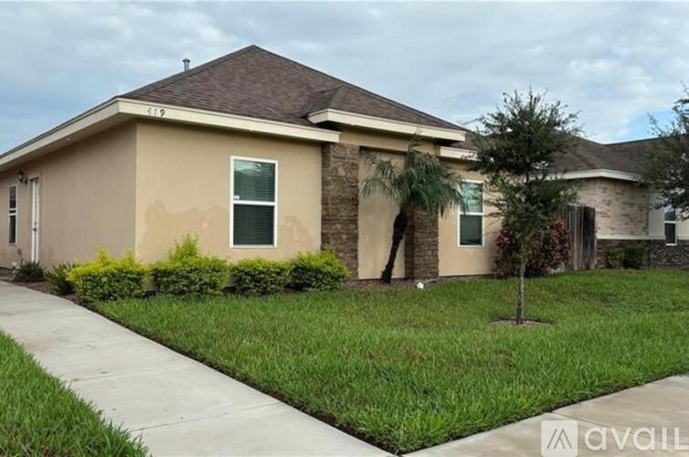 A house with a brown roof and beige walls is numbered 119.