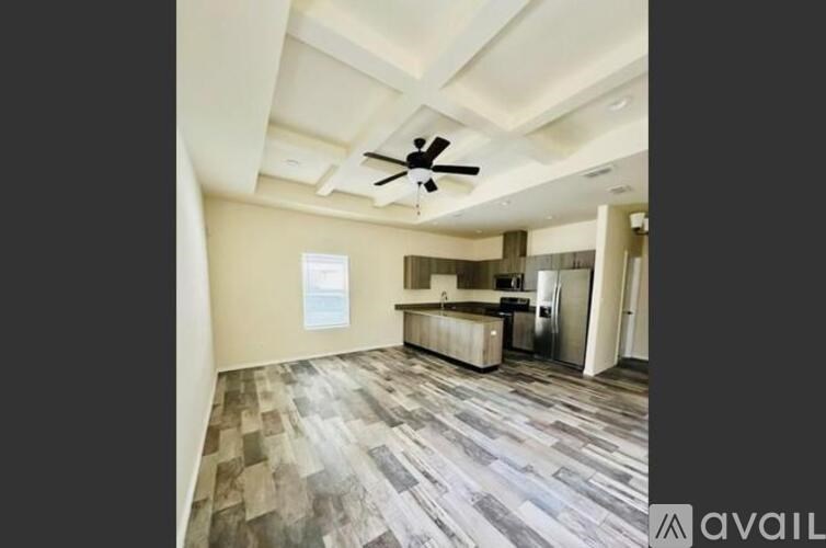 A room with a ceiling fan and a checkered floor.