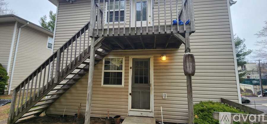 A house with a staircase leading to a balcony.