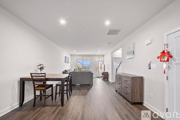 A dining room with a table set for four.