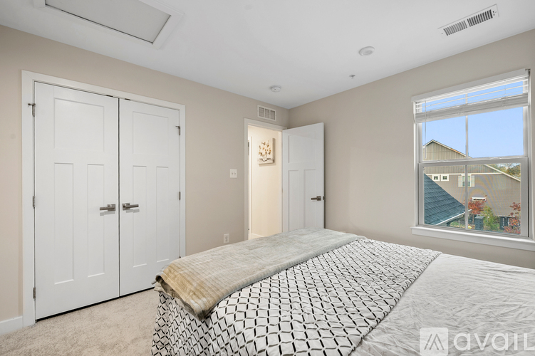 A bedroom with a bed, dresser, and mirror.