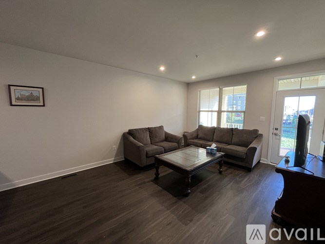 A living room with a grey couch and a coffee table.