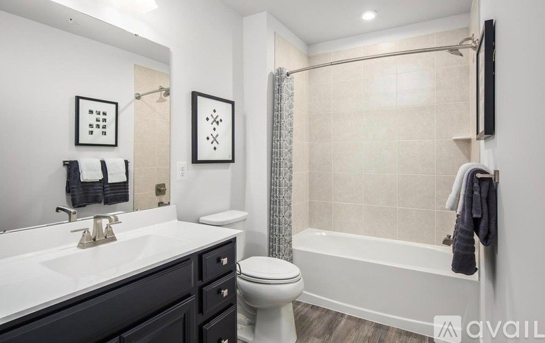 A bathroom with a white toilet, a white sink, and a white bathtub.