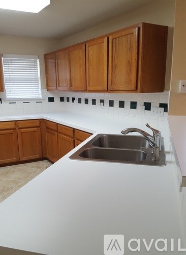 A kitchen with wooden cabinets and a white countertop.