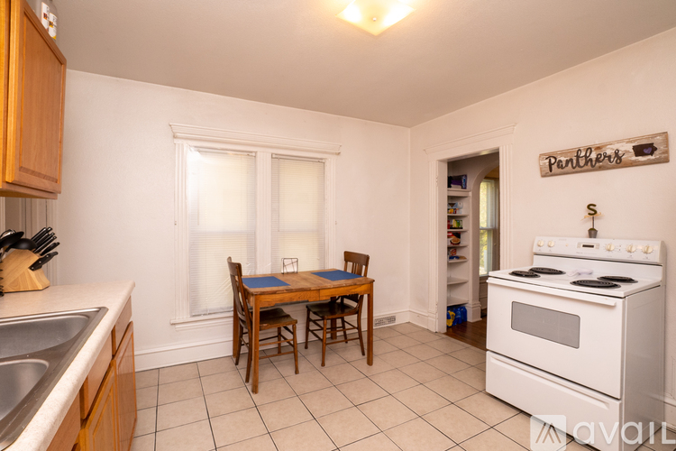 A kitchen with a table and chairs in the middle of the room.