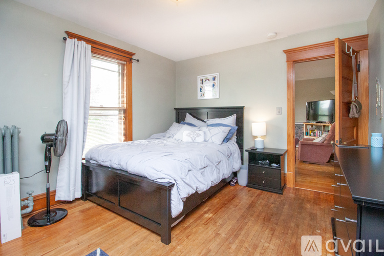 A bedroom with a large bed and a fan.
