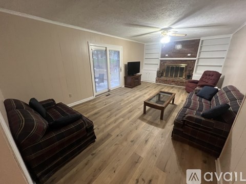 A living room with a fireplace and a television.