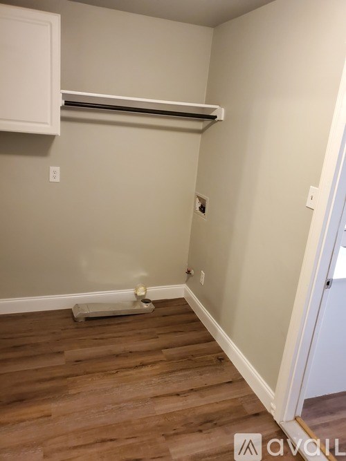 A room with a white cabinet and a white wall.