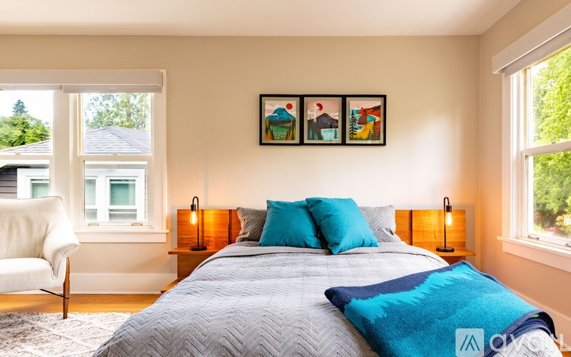 A bedroom with a bed, a chair, and a window.