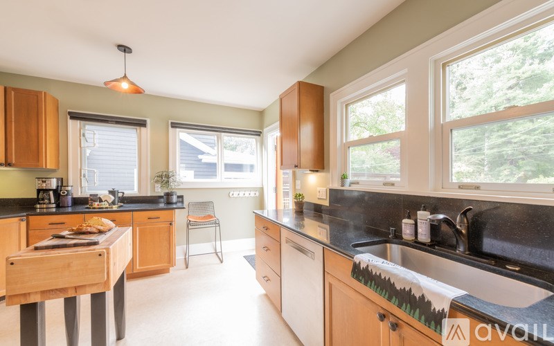 A kitchen with wooden cabinets and a black countertop.