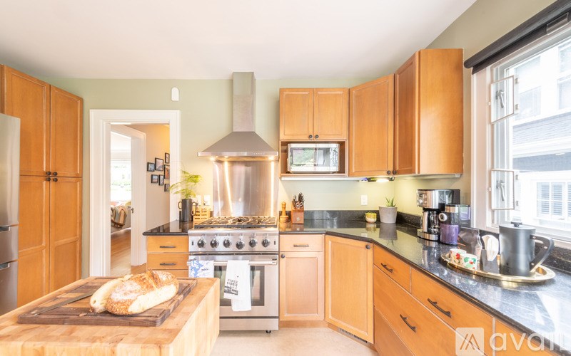 A kitchen with wooden cabinets and a stove top oven.