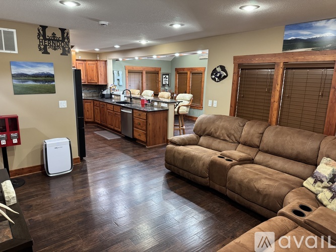 A kitchen with a refrigerator and a couch.