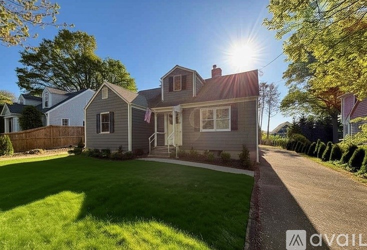 A house with a flag on the front porch is for sale.