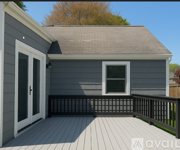 A small house with a deck and a window.