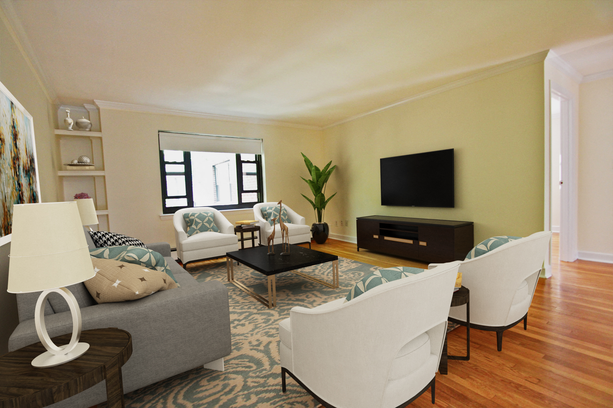 a living room with white furniture and a tv
