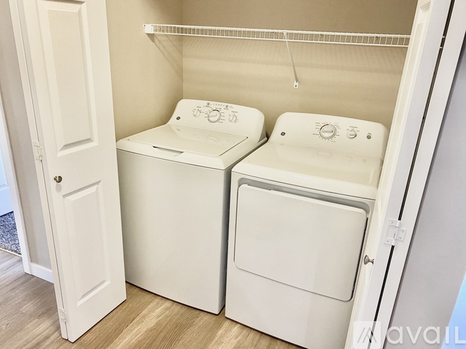 A kitchen with a white dishwasher and a white refrigerator.