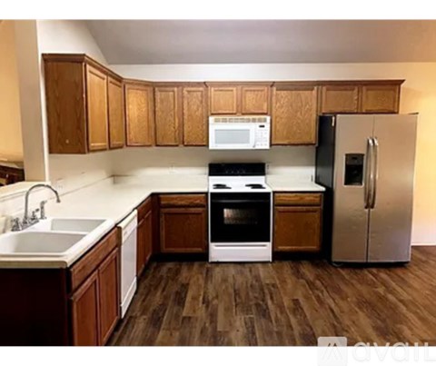 A kitchen with wooden cabinets and a white countertop.