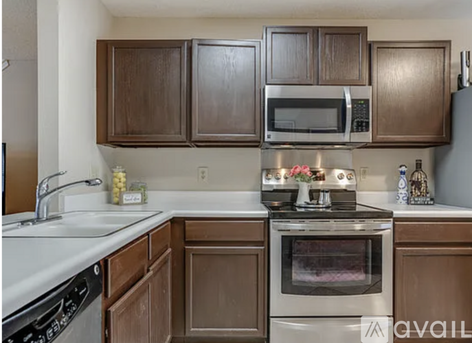 A kitchen with brown cabinets and a white countertop.