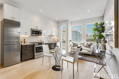 A modern kitchen with a dining table and chairs.