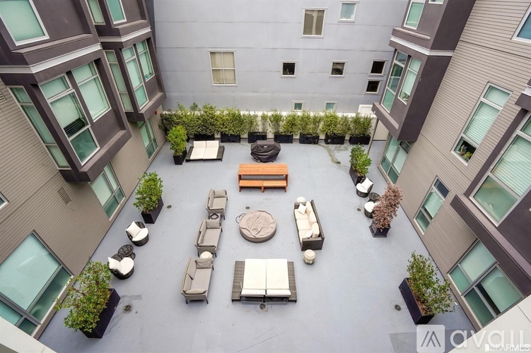 A courtyard with a fountain and seating area surrounded by buildings.