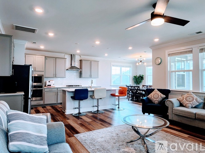A modern kitchen and living room with a dining area.