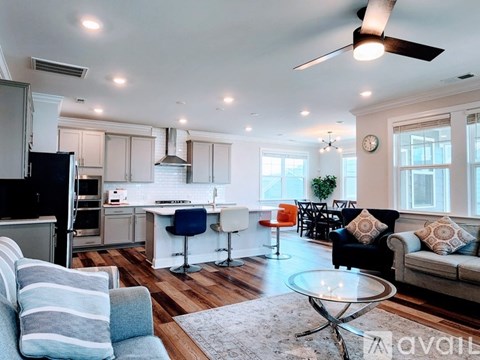 A modern kitchen and living room with a dining area.