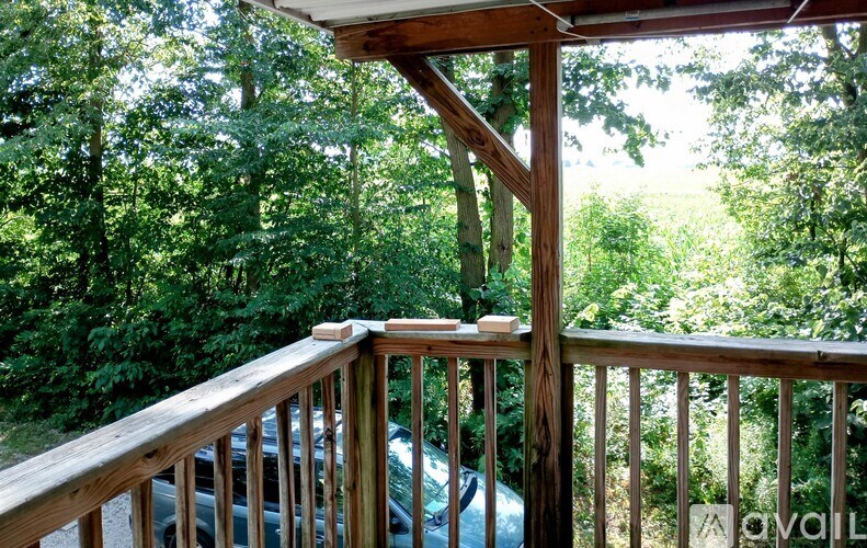 A car is parked on a wooden deck.
