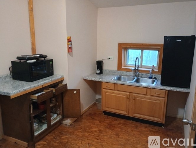 A kitchen with wooden cabinets and a granite countertop.