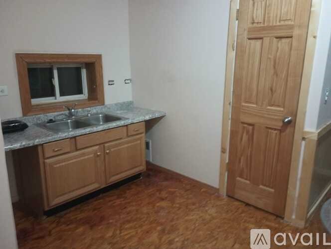 A kitchen with wooden cabinets and a marble countertop.