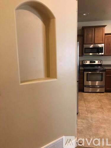 A kitchen with a stove and microwave.