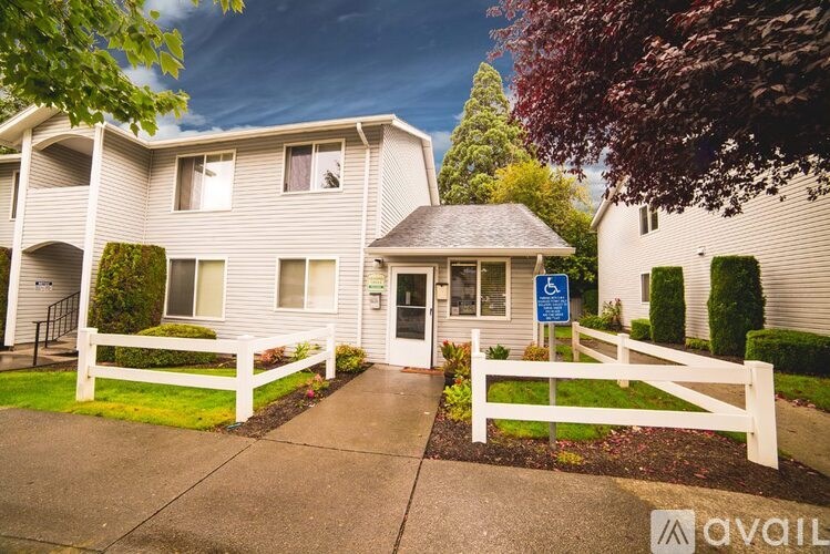 A building with a white picket fence in front of it.