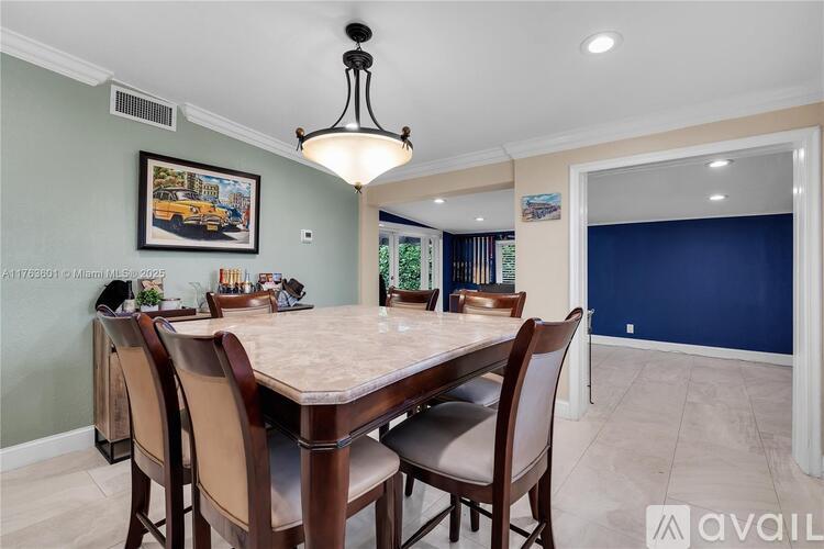 A dining room with a table set for six.
