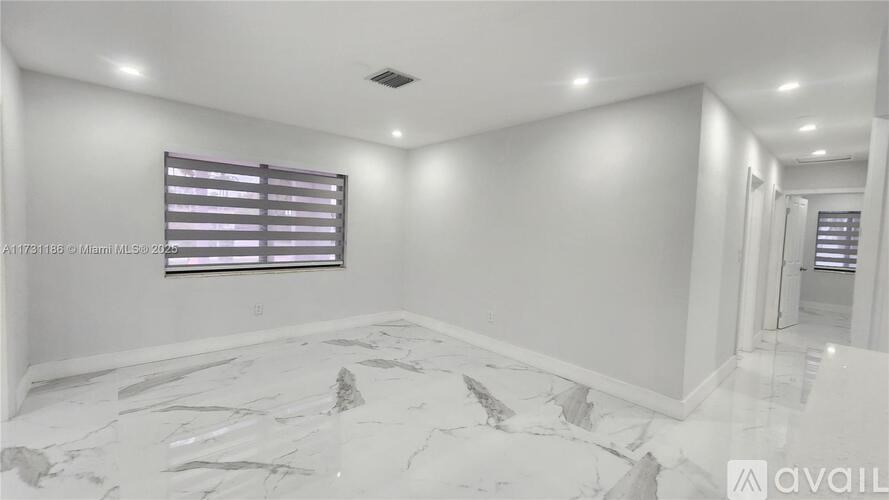 A room with white walls and a marble floor.