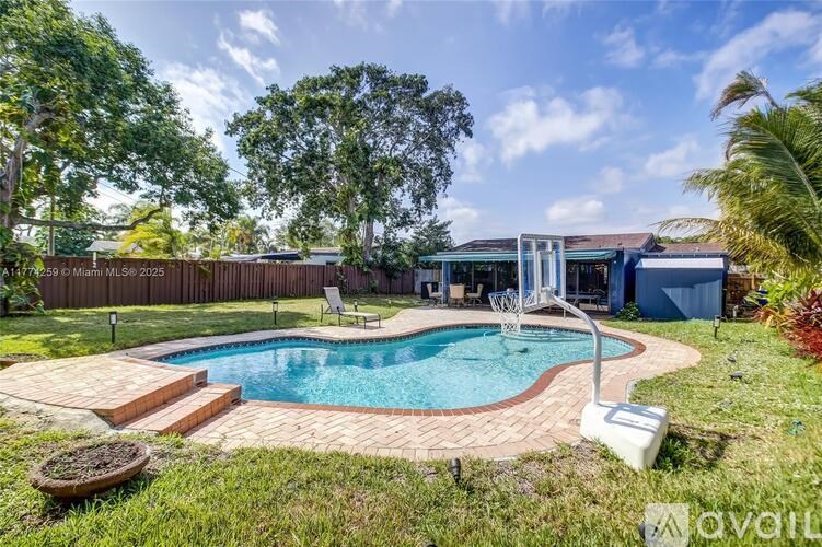 A backyard with a small pool and a fence.